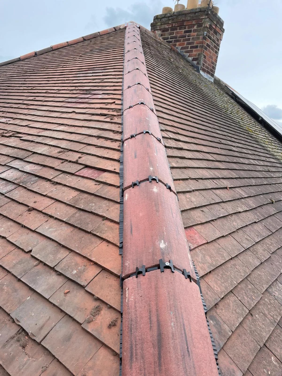 The same ridge after the tiles were re-bedded and repaired